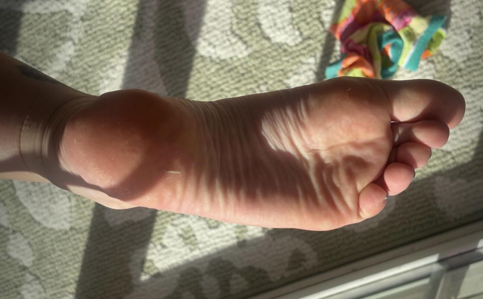 Ash removing socks to show her blue toes and hot soles