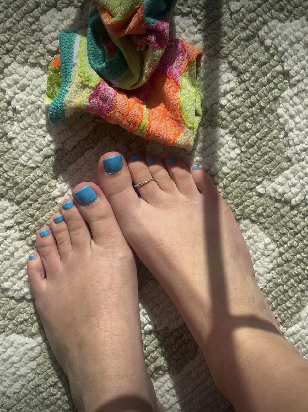 Ash removing socks to show her blue toes and hot soles